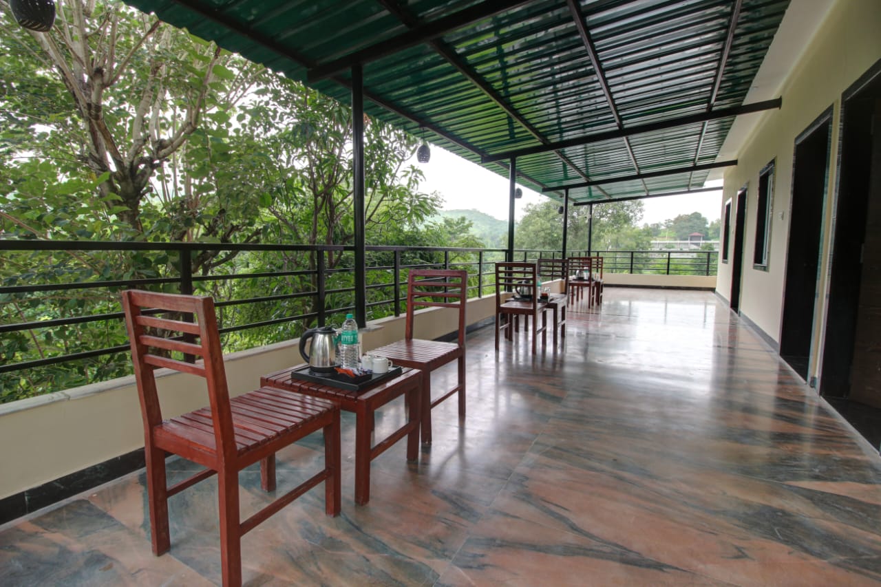 Private balcony with seating overlooking the hills