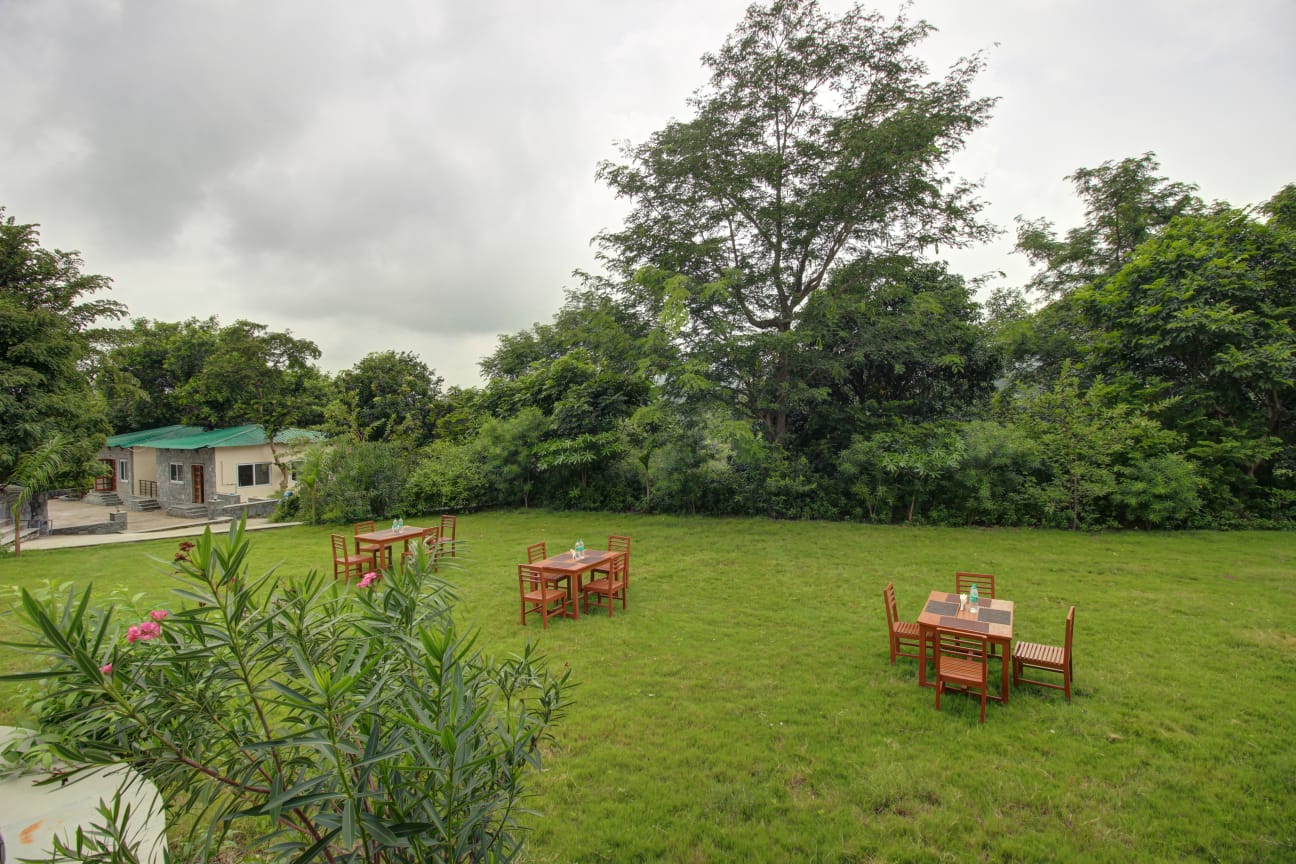 Takhat Villa garden seating area surrounded by lush greenery