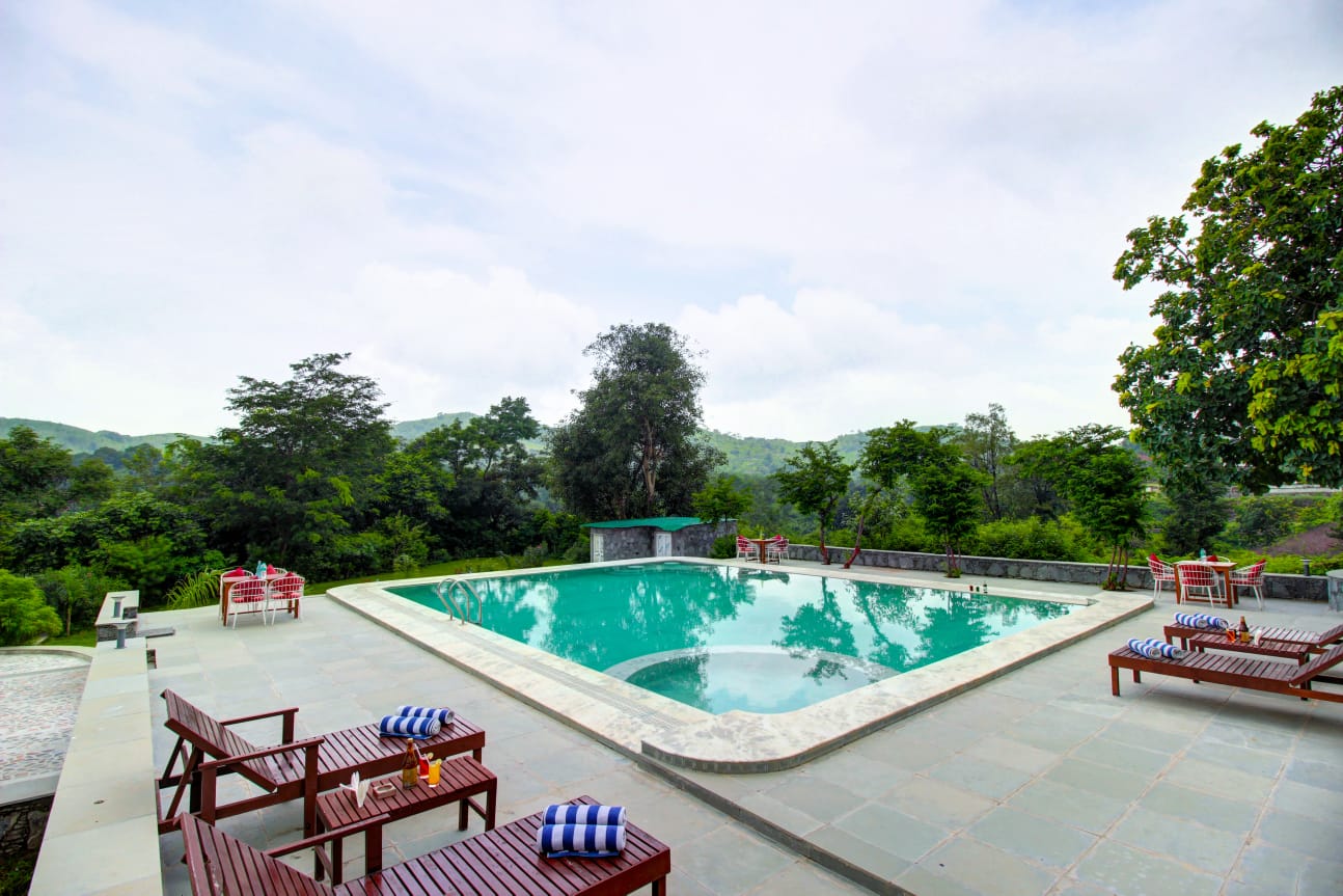 Pool area with loungers at sunset